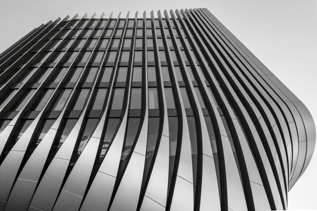 Modern architectural design of a futuristic high-rise building with sleek lines in Prague.